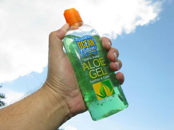 Bottle of aloe vera gel in hand